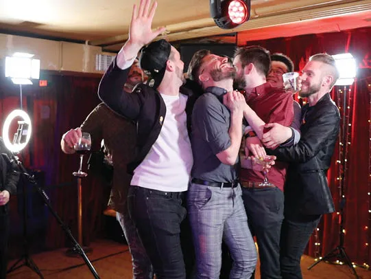 Coworkers laughing on the XL 360 platform as camera arm spins