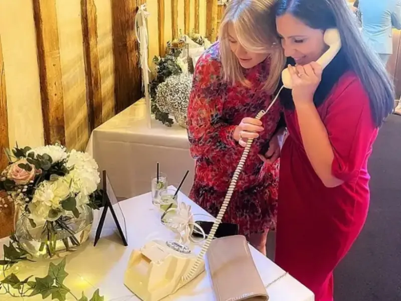 Audio guestbook display with floral décor arrangement