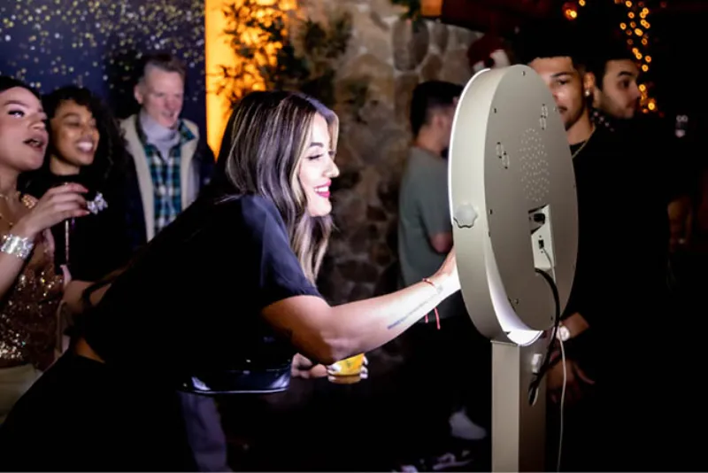 GIF booth with LED lights and mirror accents at a wedding reception