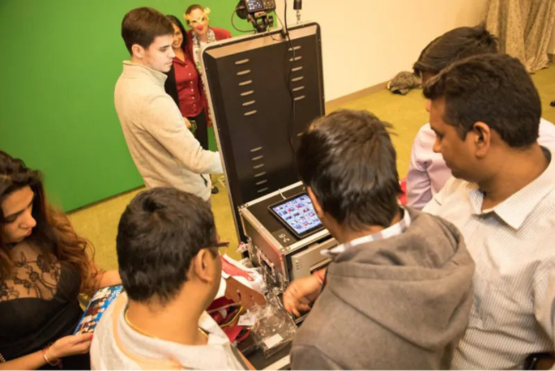 iPad photo sharing station at an event with guests in background