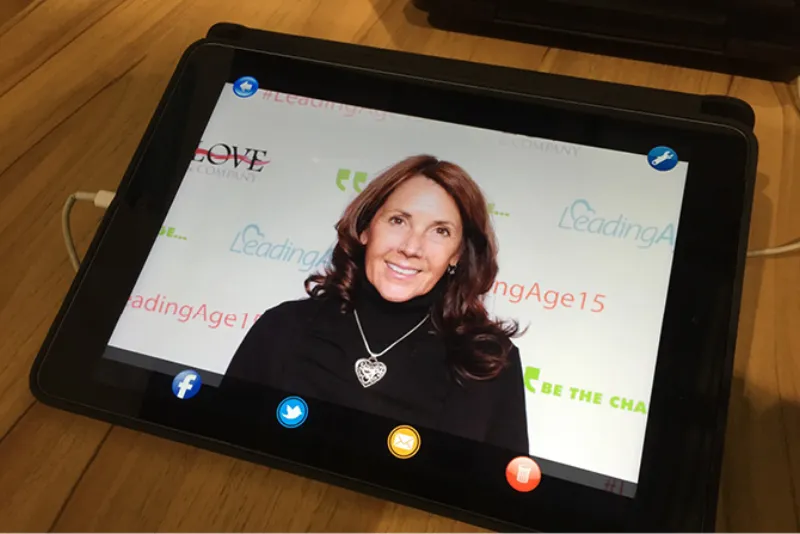 Guests using an iPad sharing kiosk at a corporate photo booth event