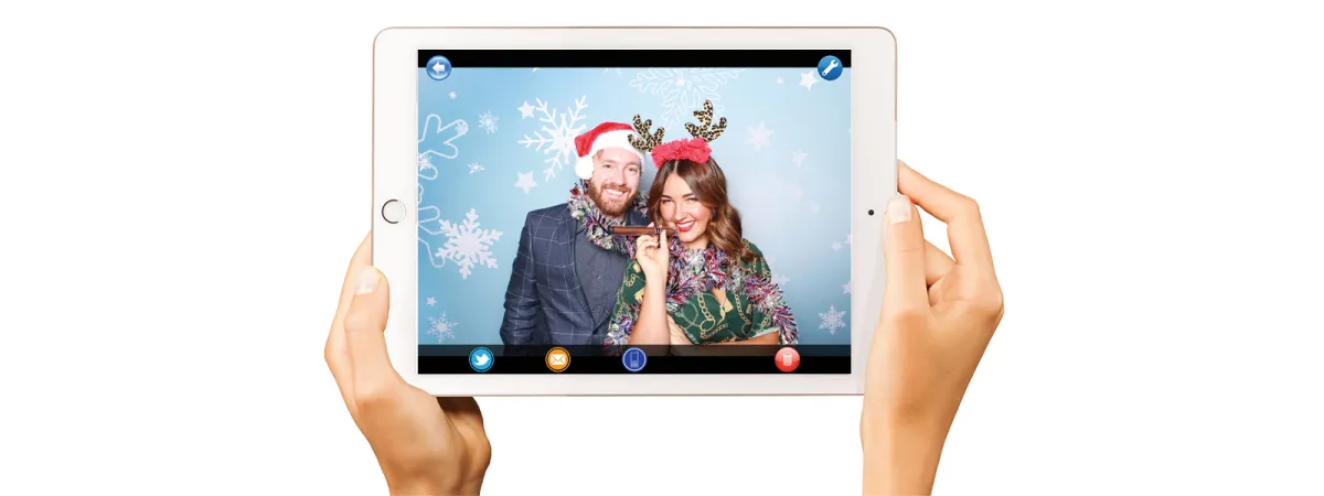iPad sharing station set up next to a photo booth at an event