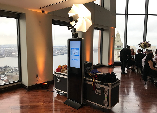 Mirror tower and printer in use by couple with props at a special party or wedding event