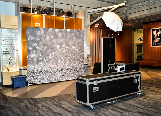 Open Air photo booth setup with custom backdrop at an event