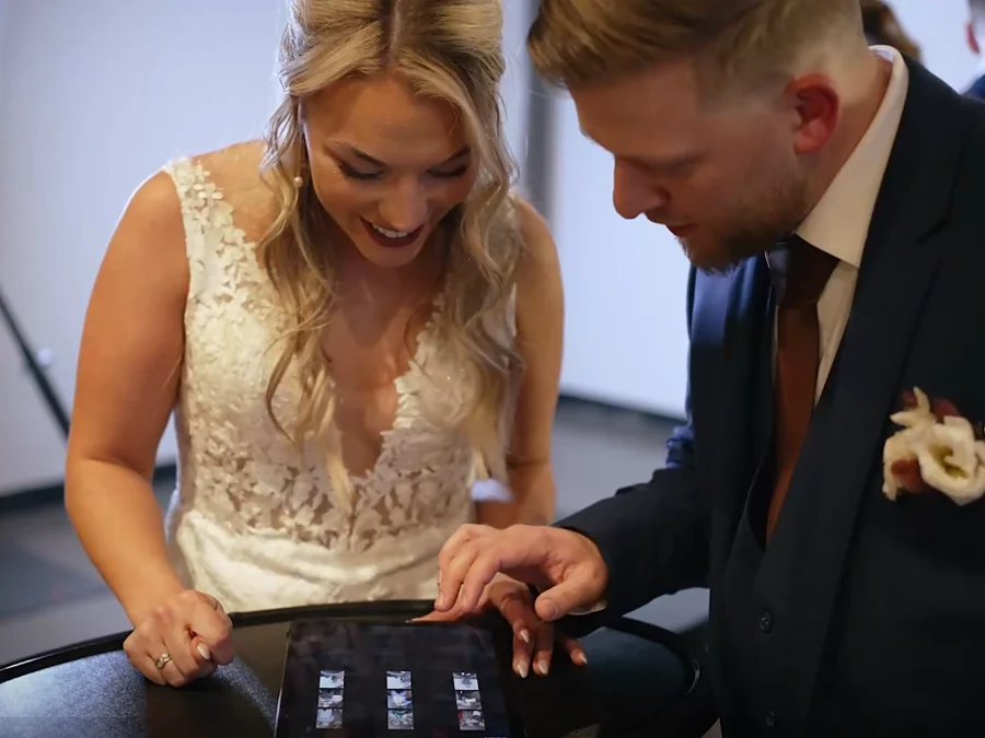 Bride and groom sharing their photo booth pictures at the iPad sharing station