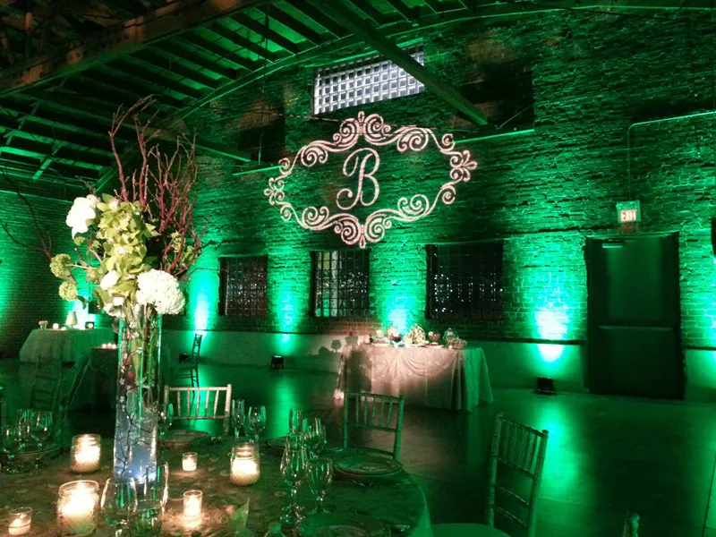 Wedding reception with warm amber uplighting on walls