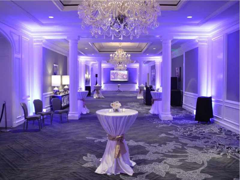 Party venue with dramatic uplighting illuminating the room