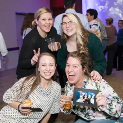 Guests holding printed photos from the Roaming Eventographer