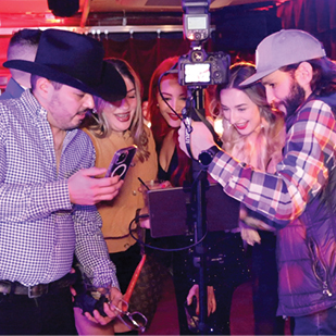 Roaming Booth Group Viewing Their Photos