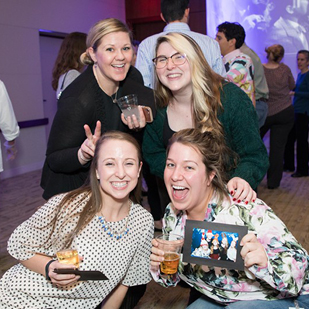 Female Coworkers Pose For Roaming Photographer Photos