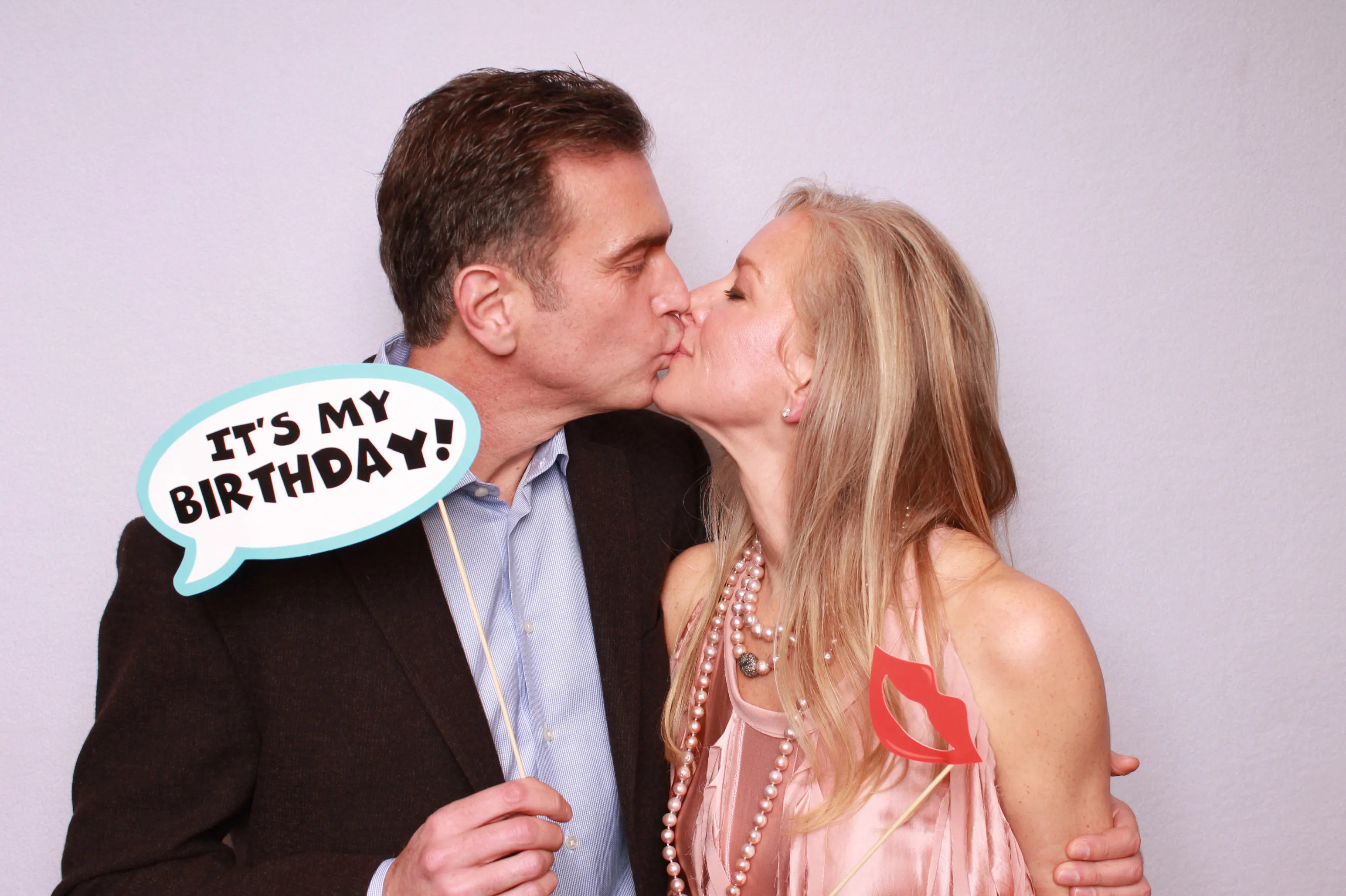 Birthday guests posing at photo booth