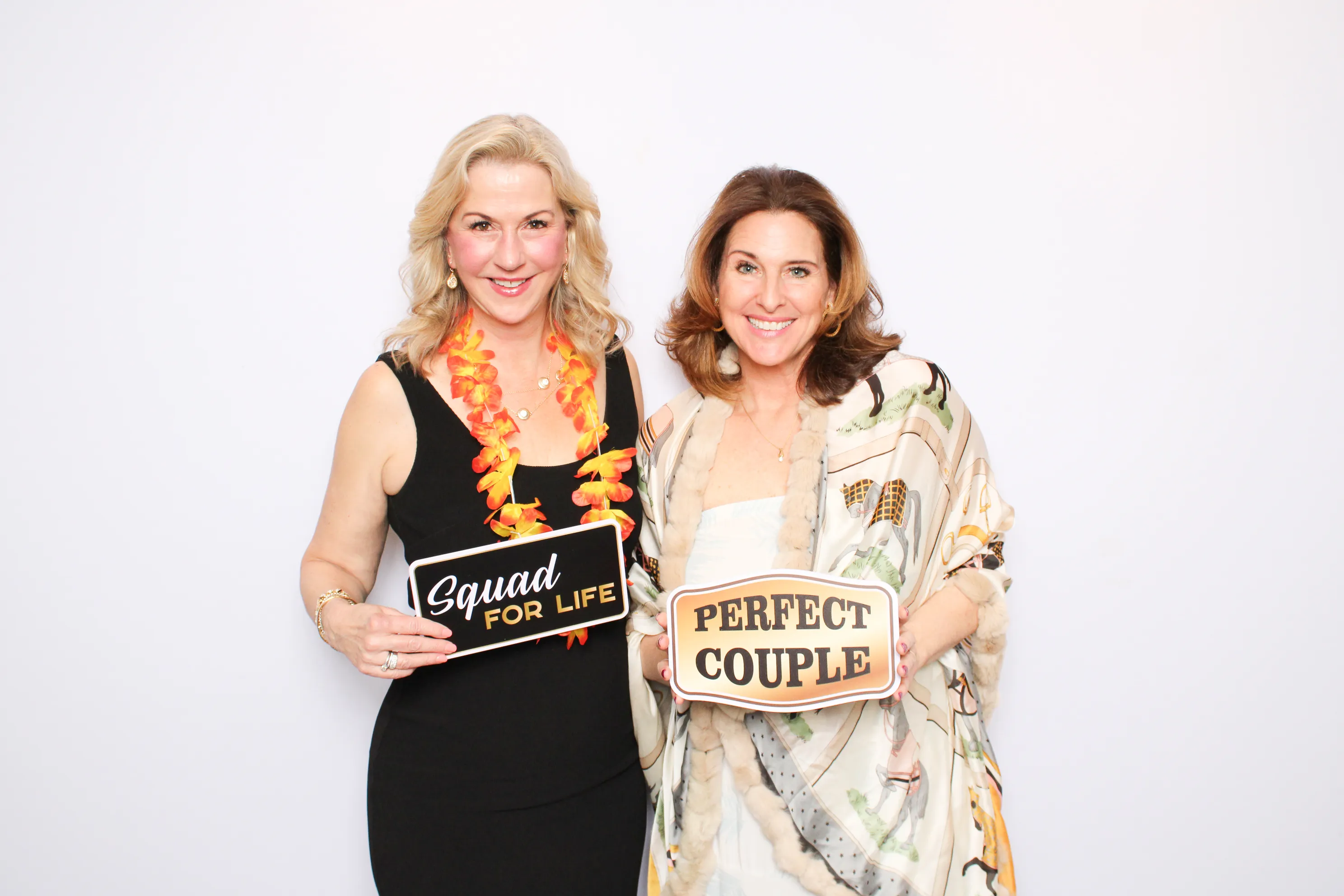 Party guests having fun at photo booth