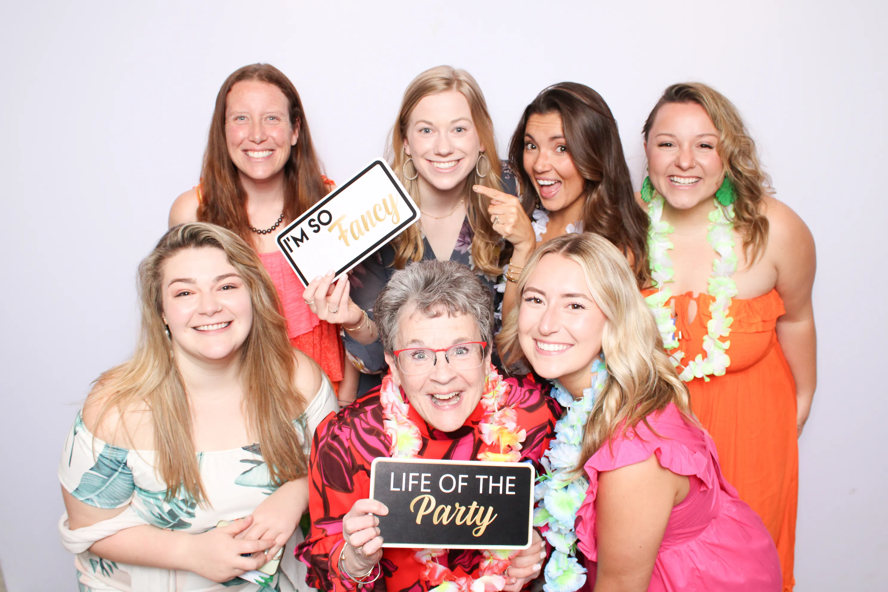 Birthday guests posing with fun props at photo booth
