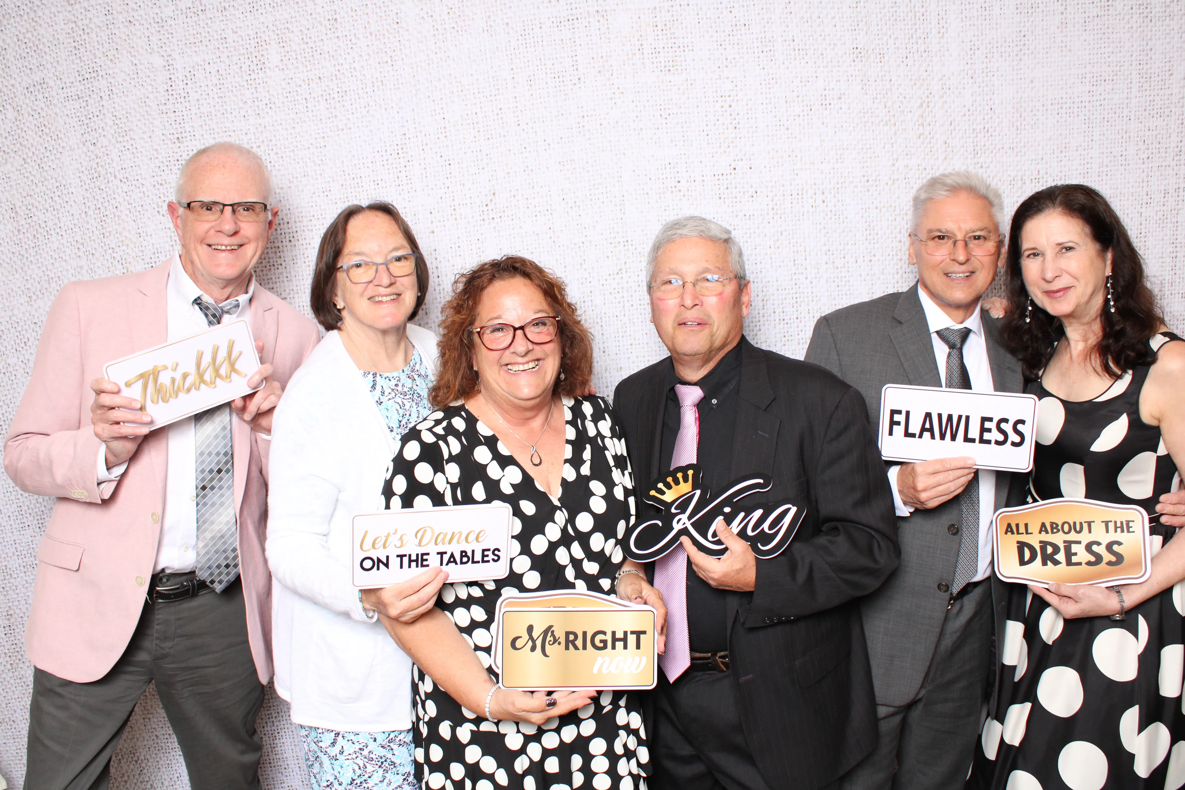 Team members posing at corporate event photo booth