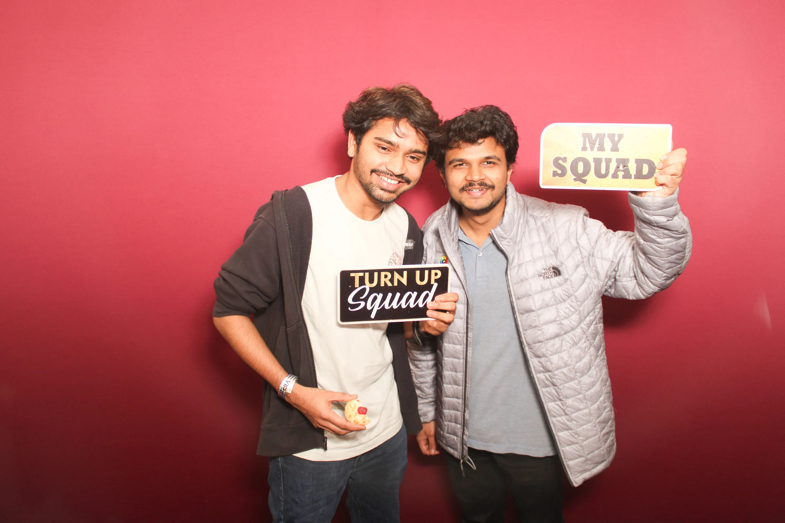 Newlyweds and family at wedding reception photo booth