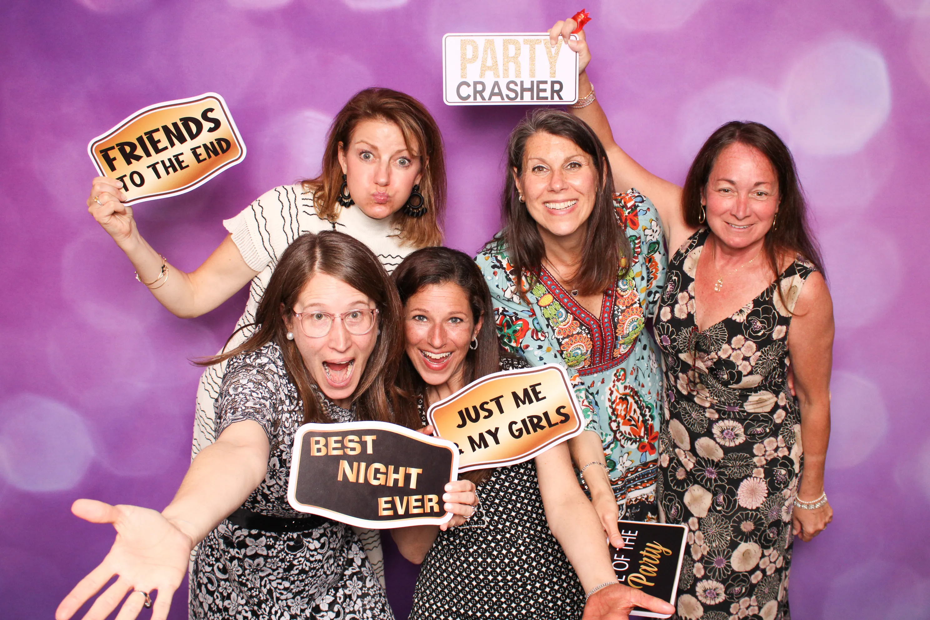Guests in festive attire at party photo booth