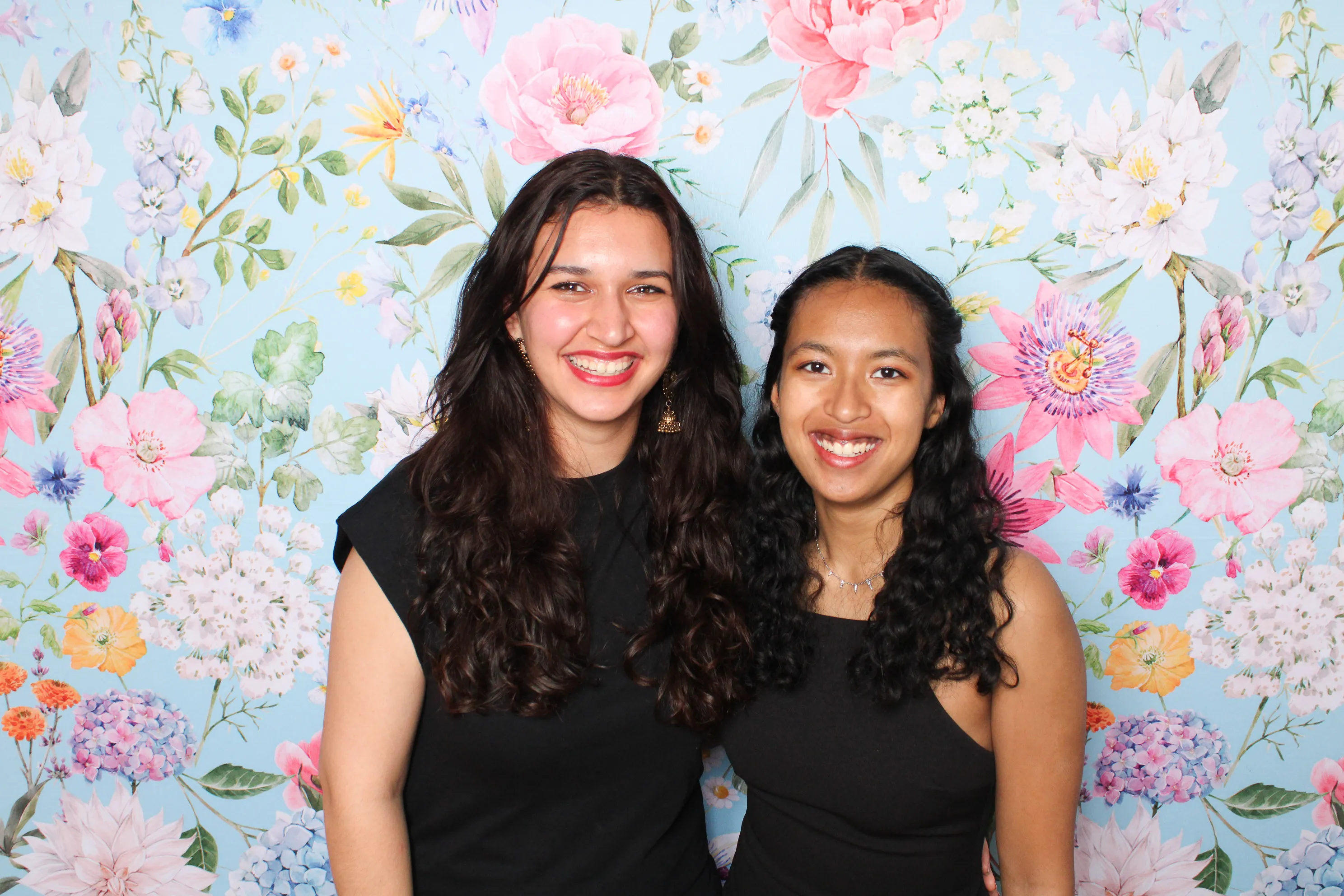 Bridesmaids laughing together at wedding photo booth