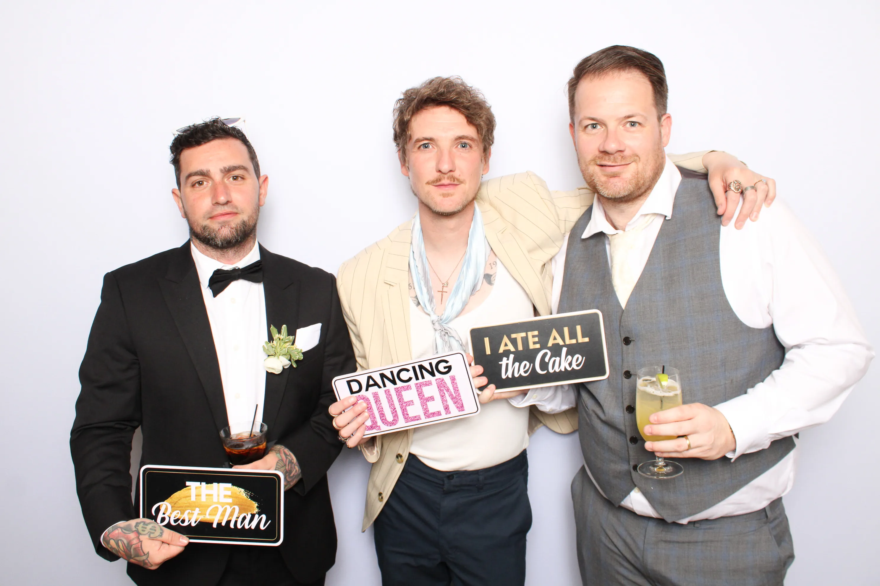 Wedding guests enjoying photo booth at reception
