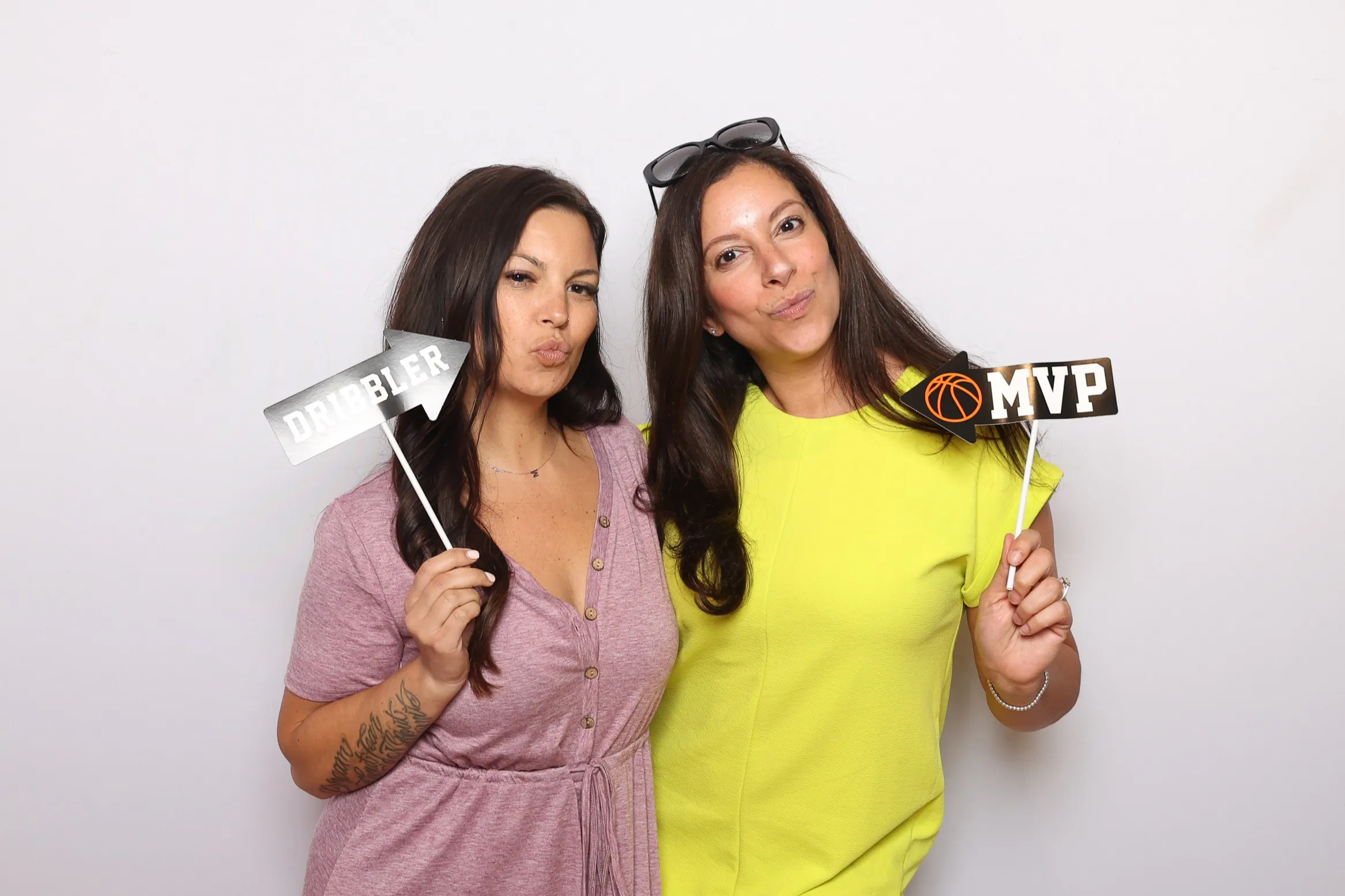 Party guests striking poses at photo booth