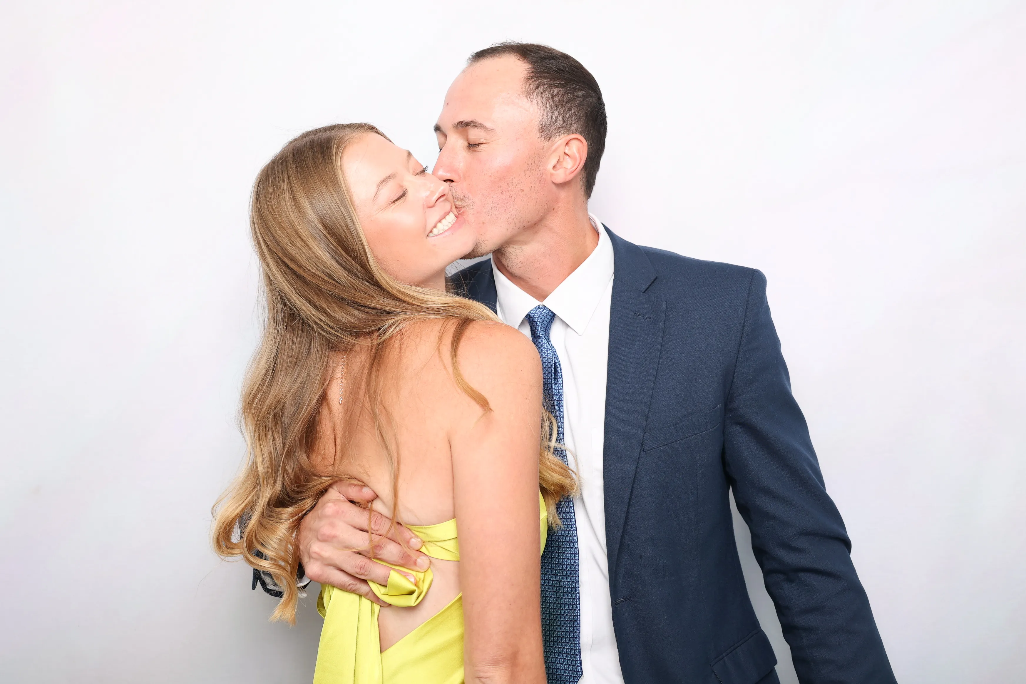 Friends striking fun poses at photo booth