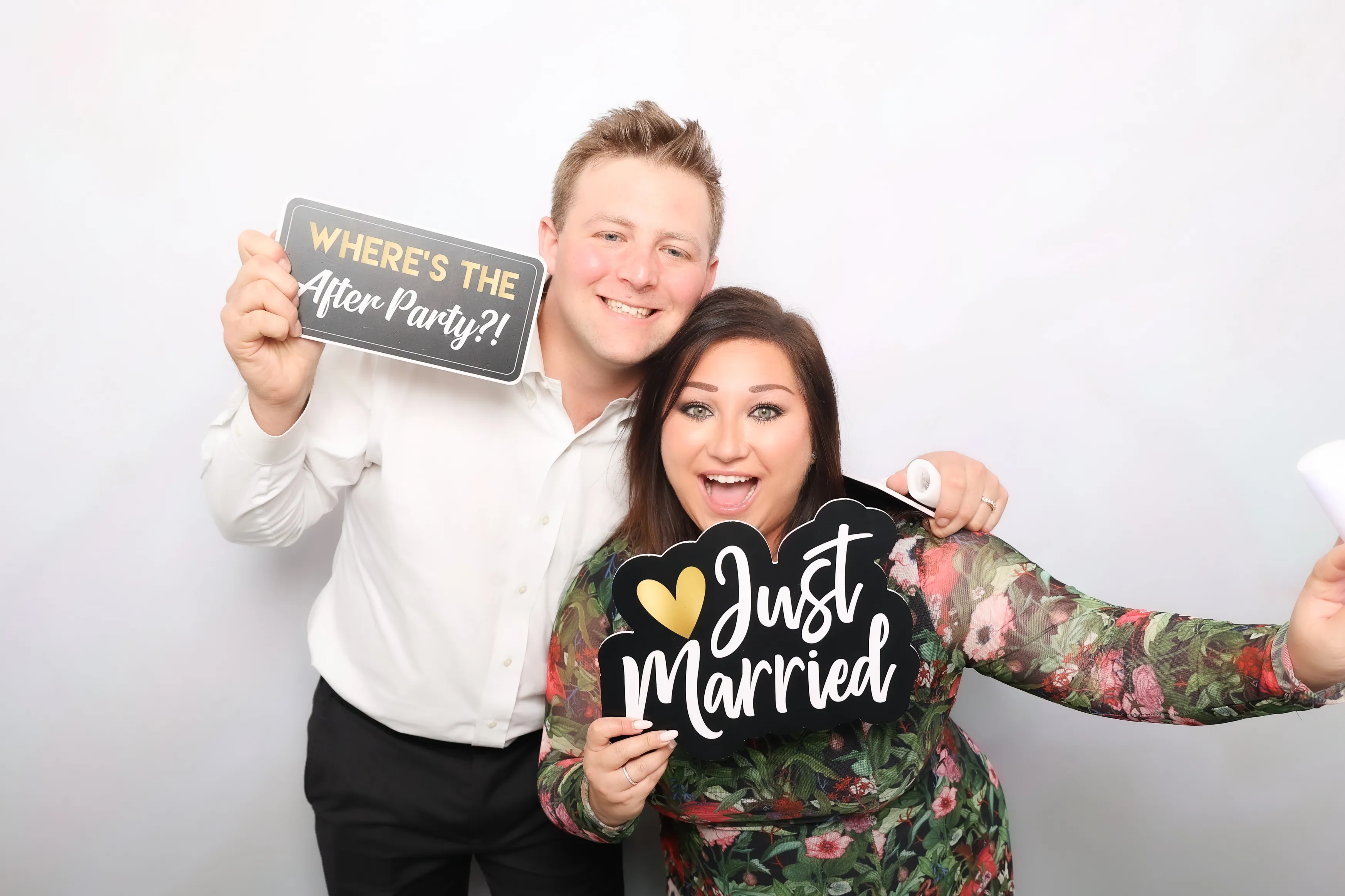 Friends posing with props at event photo booth