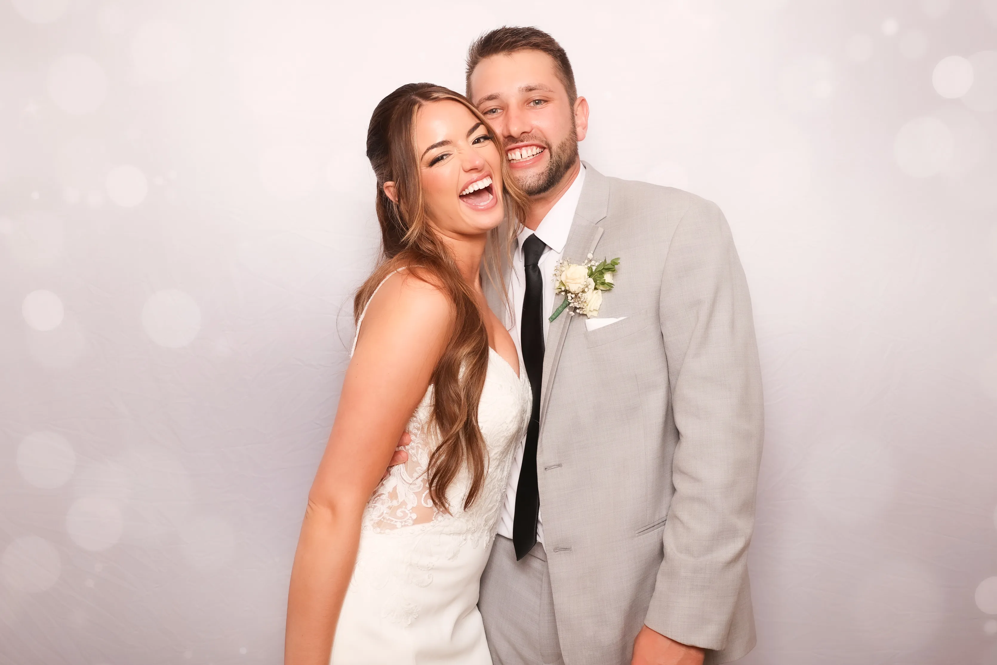 Wedding couple with family at photo booth