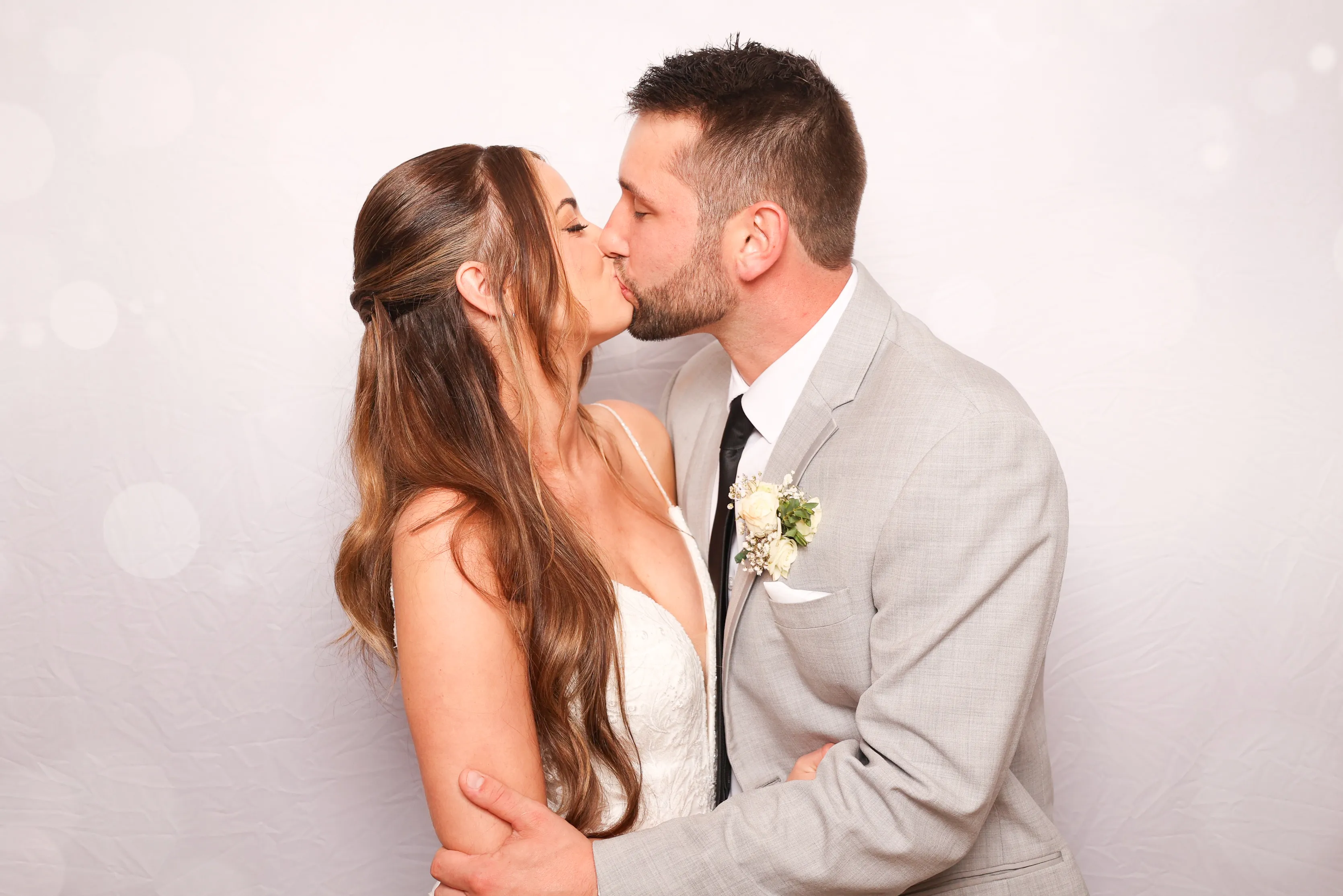 Guests in elegant attire at wedding photo booth