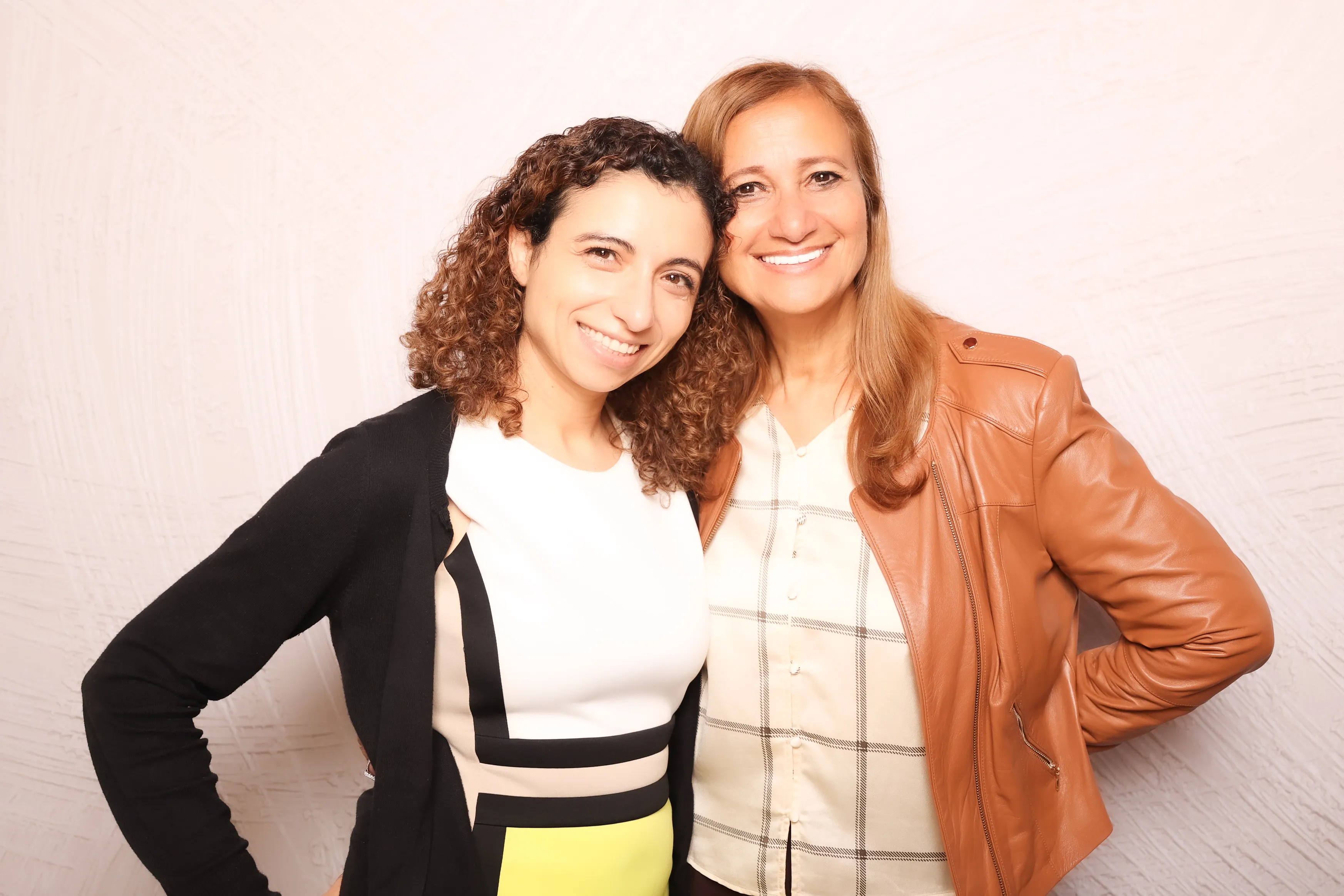 Friends laughing together at party photo booth