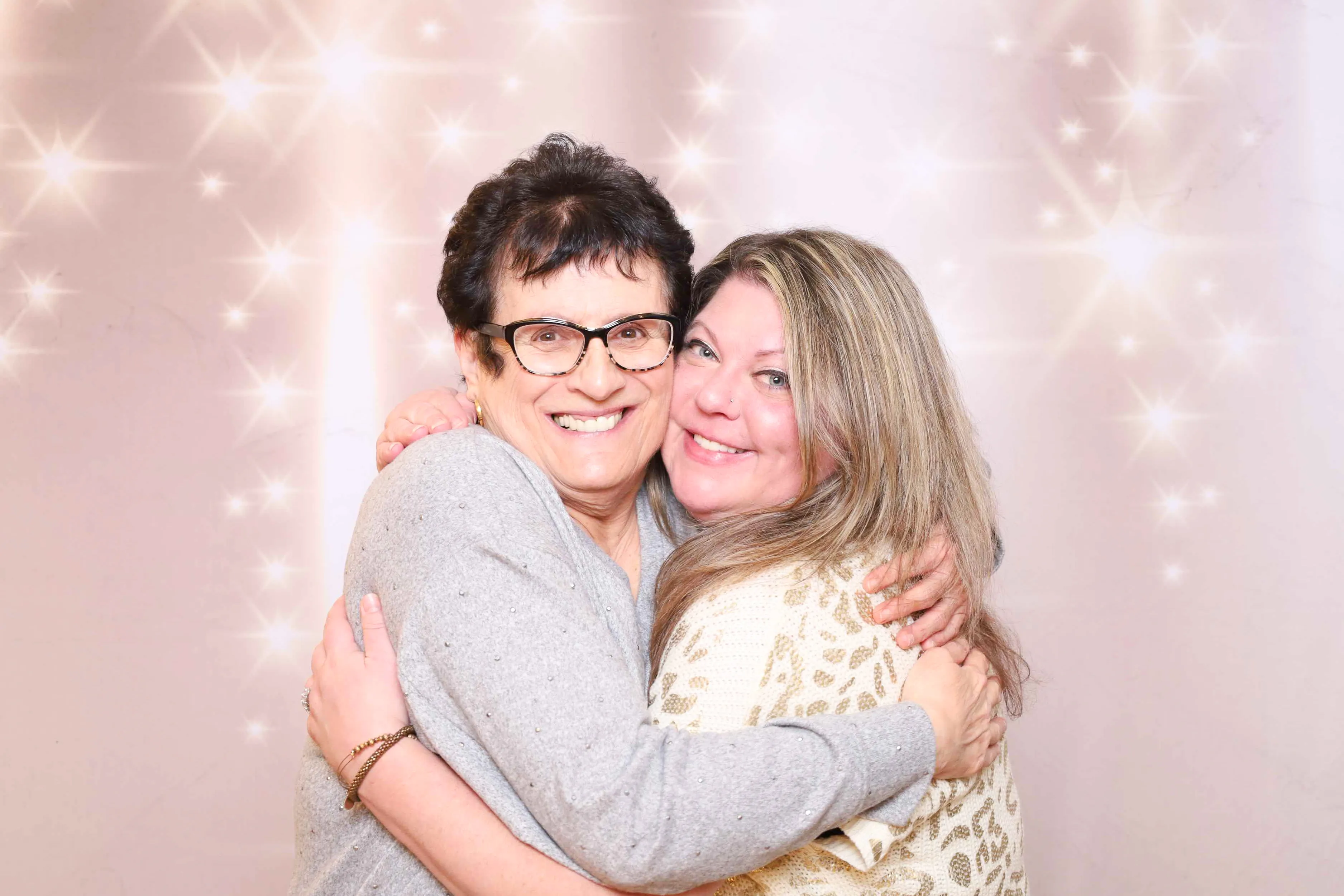 Guests posing with feather boas at photo booth