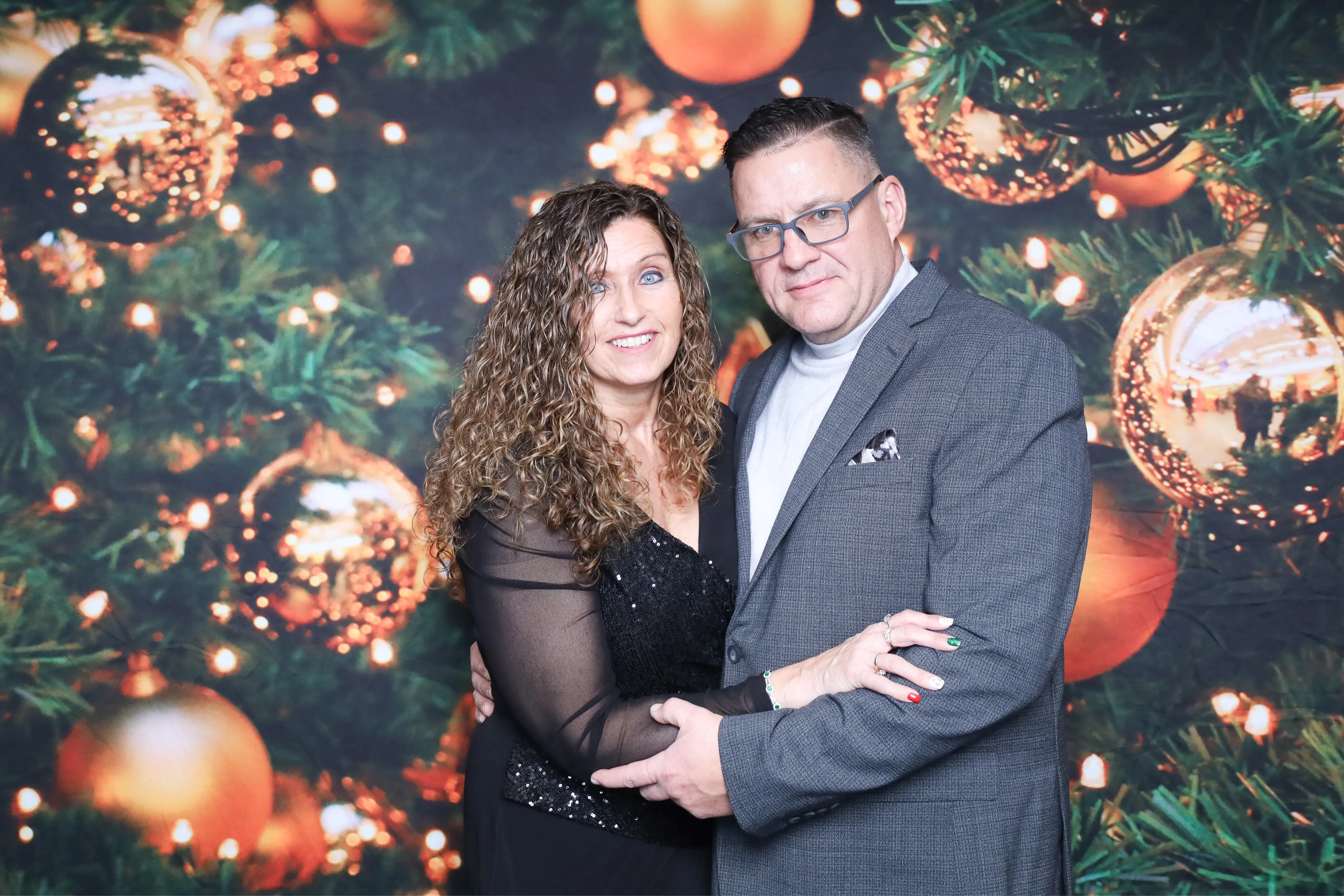 Friends laughing with sign props at photo booth