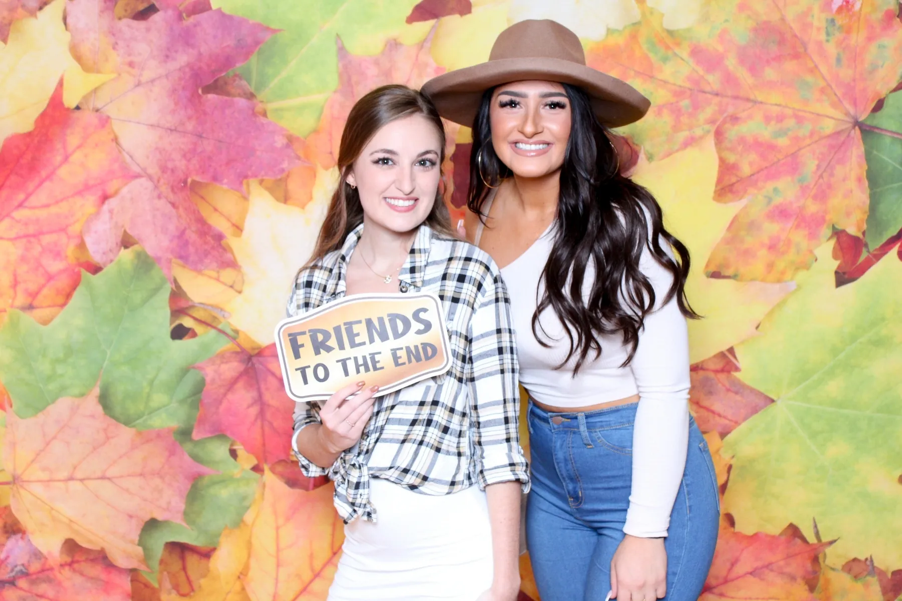Photo booth with fall foliage backdrop