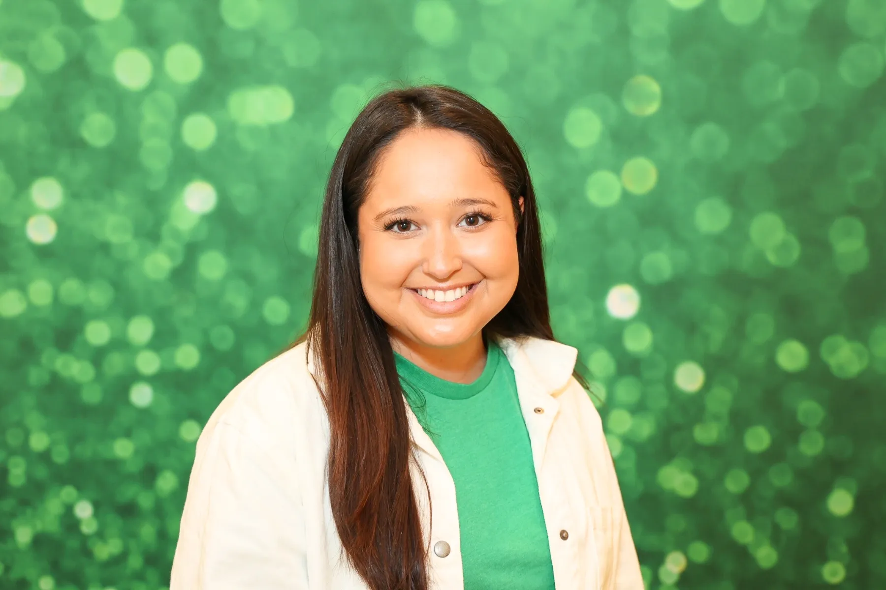Open air photo booth with green sparkle backdrop