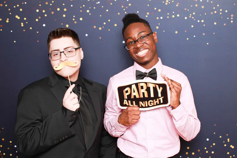 Photo booth guests smiling for the camera