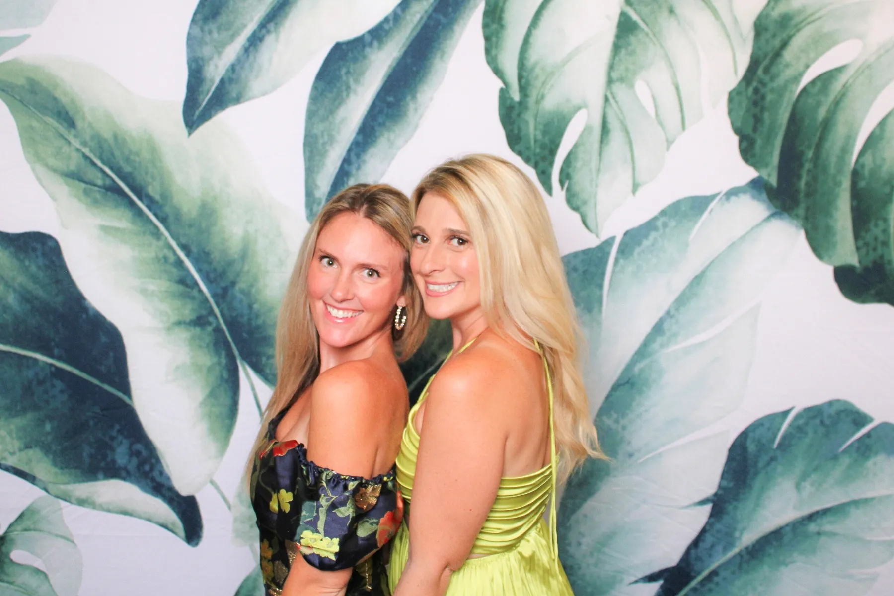 Tropical monstera leaf backdrop at photo booth