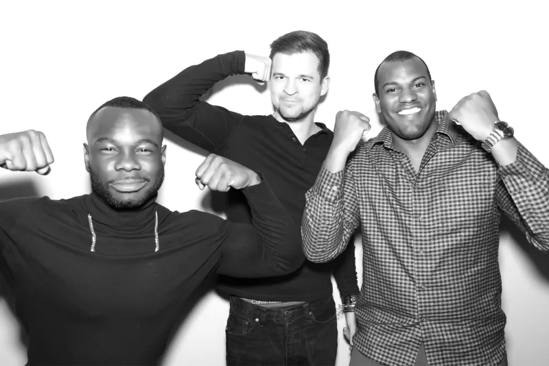 Three men at party with black and white GLAM filter