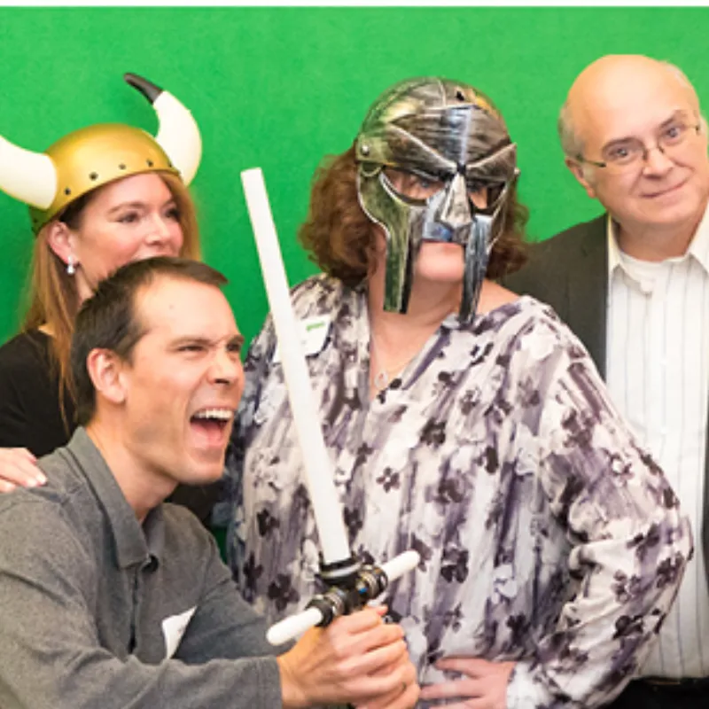 Family poses for green screen photo booth pictures