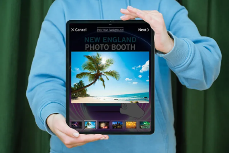 Guests using green screen photo booth with live background preview on screen