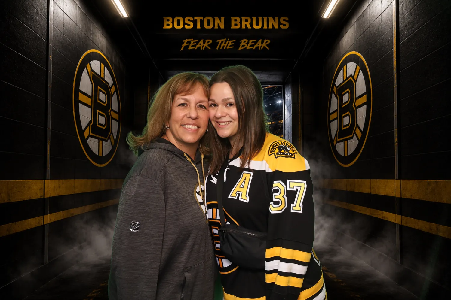 Mother and daughter in the Boston Bruins locker room green screen background