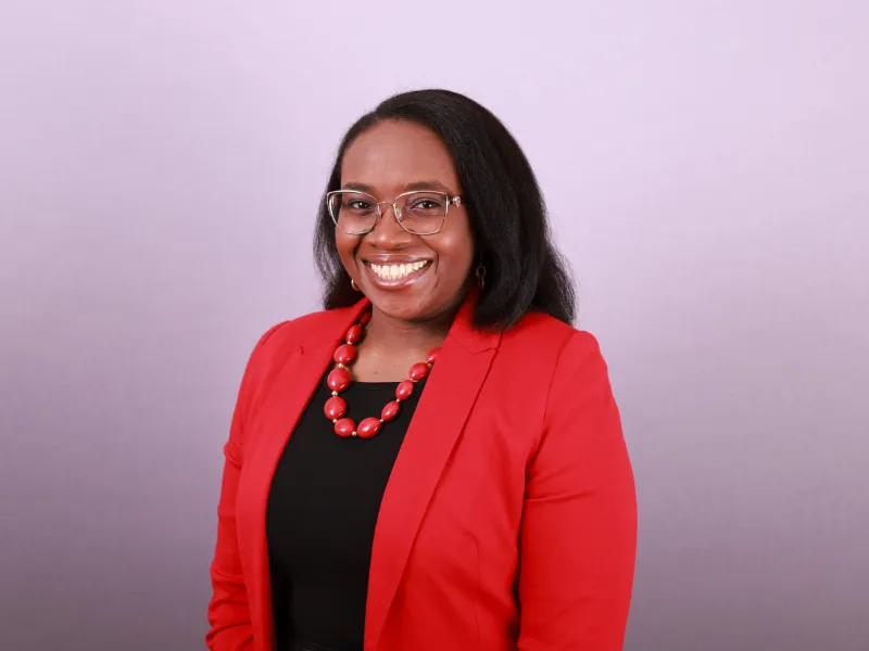 Professional corporate headshot of a business executive on a clean backdrop