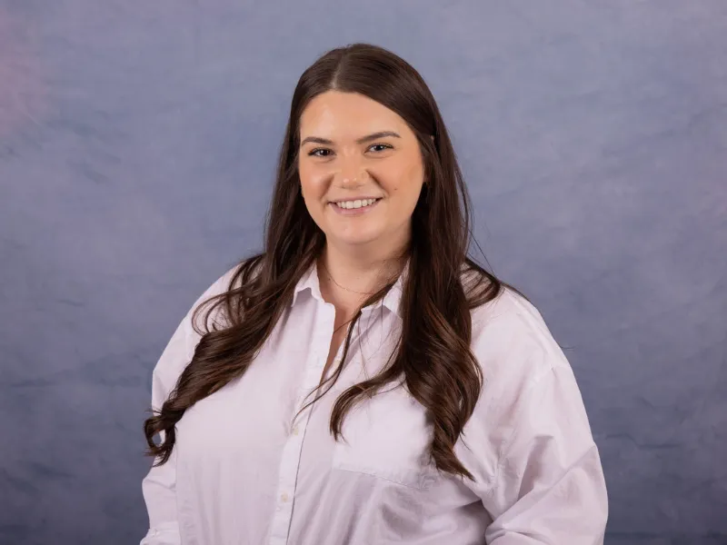 Corporate headshot with professional lighting and neutral background