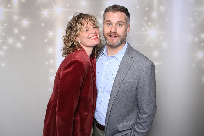 Young girls at a bar/bat mitzvah with a white back drop