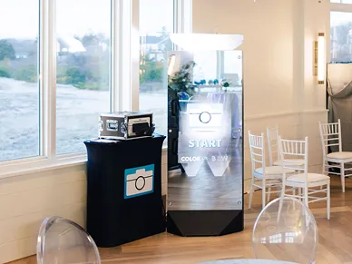Mirror Booth setup with purple backdrop and props at a private event