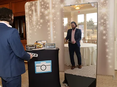 Guests using the Mirror Booth with custom branding at a corporate event