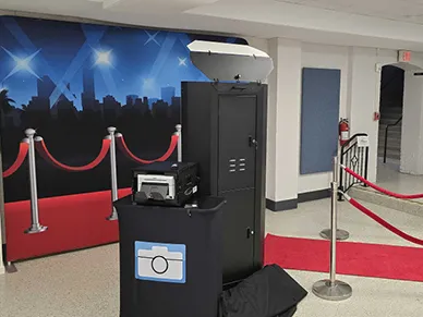 Couple posing in front of the Mirror Booth with handheld sign props