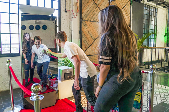 Mirror tower and printer in use by couple with props at a special party or wedding event