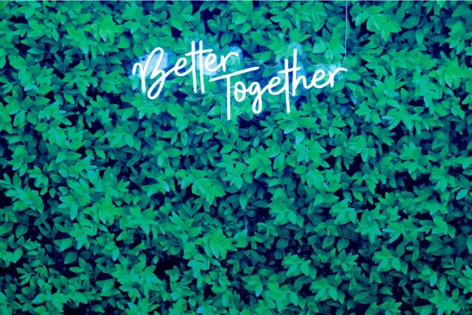 Better Together neon sign glowing at a wedding reception