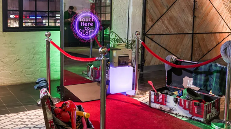 Red carpet and velvet stanchions creating a VIP entrance for photo booth guests