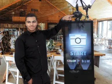 Open Air Photo Tower booth with backdrop at an evening event