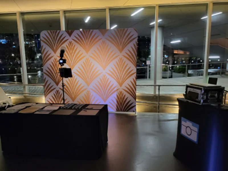 Guests posing at the HD Tripod Pro booth at a wedding reception
