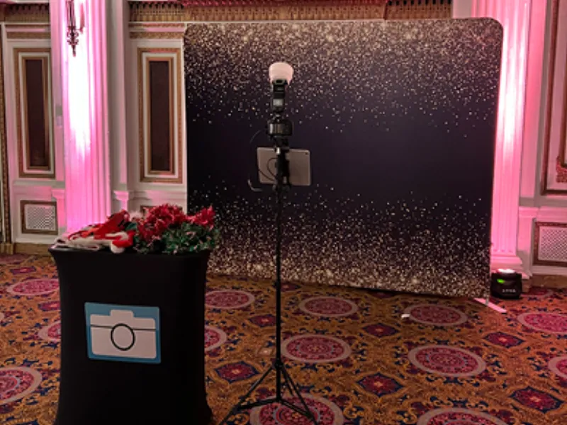 Couple using the HD Tripod Pro booth with custom backdrop